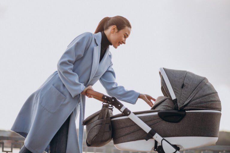 young-mother-walking-with-baby-carriage-park